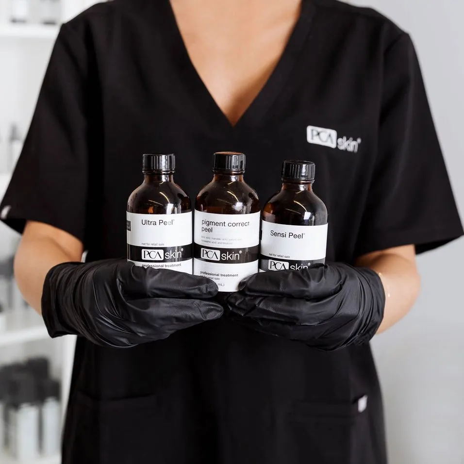 Lady holding bottles of PCA SKIN